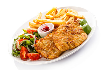 Fried pork chop, French fries and vegetables 