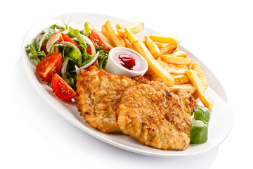 Fried pork chop, French fries and vegetables 