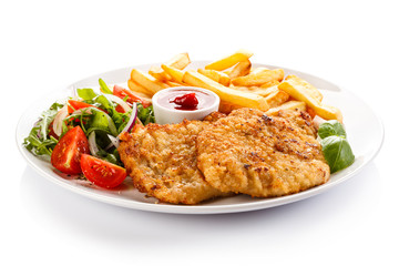 Fried pork chop, French fries and vegetables 