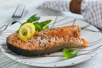 Grilled Salmon steak with lemon and herbs.