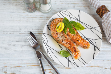 Grilled Salmon steak with lemon and herbs.
