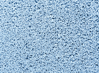 Fragment of frozen river surface with hoarfrost