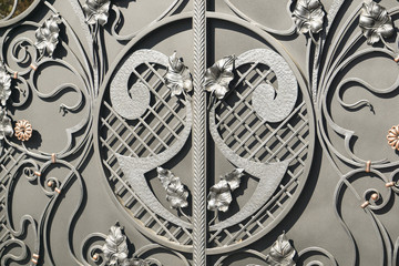 Metal art with patterns of leaves. Iron gate
