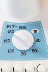 Power switching device on a white and blue Japanese electric fan