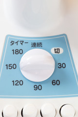 Power switching device on a white and blue Japanese electric fan