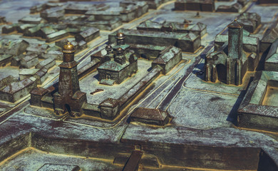 Closeup of bronze miniature model of the landmarks of Alba Carolina Citadel located in front of Reunification Cathedral in Alba Iulia.