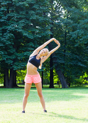 The beautiful blonde stretching outdoors