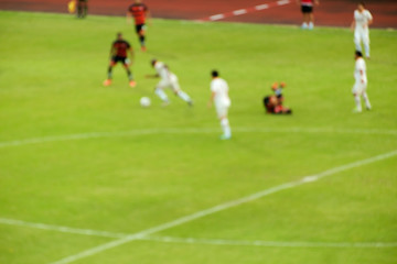 Football / Blur of football players running on the field during match.