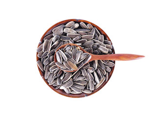 sun flowers seeds in wood spoon isolated on white background