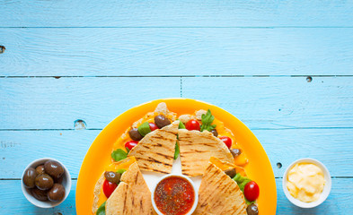 Delicious veggie quesadillas with tomatoes, olives, saòad and c