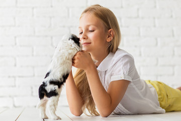 Blonde girl with a cocker spaniel puppy