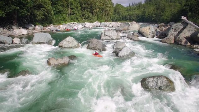 Extreme Kayaker Flowing Down River Filmed with Drone Flying Backwards
