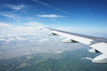 Fototapeta premium A plane's wing flying over Bhutan