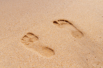 Fototapeta na wymiar Two footprint on sandy beach