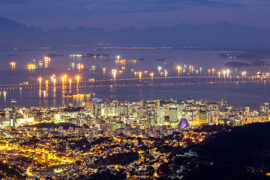 Aerial view of Rio de Janeiro downtown by night. Rio-Niteroi Bridge spans Guanabara Bay