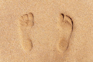Fototapeta na wymiar Two footprint on sandy beach