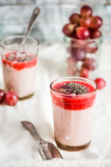 oatmeal pudding with strawberry sauce and grapes, rustic