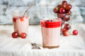 oatmeal pudding with strawberry sauce and grapes, rustic