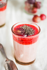 oatmeal pudding with strawberry sauce and grapes, rustic
