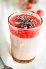 oatmeal pudding with strawberry sauce and grapes, close-up