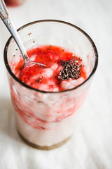 oatmeal pudding with strawberry sauce and grapes, close-up