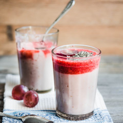 oatmeal pudding with strawberry sauce and grapes, rustic