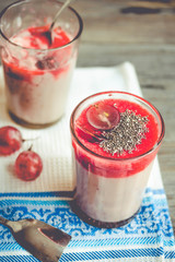 oatmeal pudding with strawberry sauce and grapes, rustic