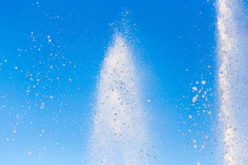water splashing from the fountain in the background of blue sky
