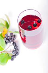 Glass of aronia juice with berries, overhead view