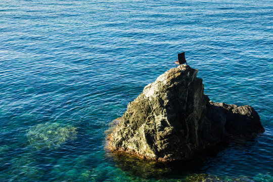 Chair of rock in the sea