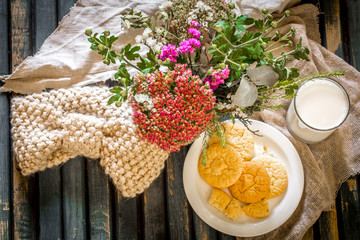 Still life on a wooden table with  plate of cookies and glass  milk