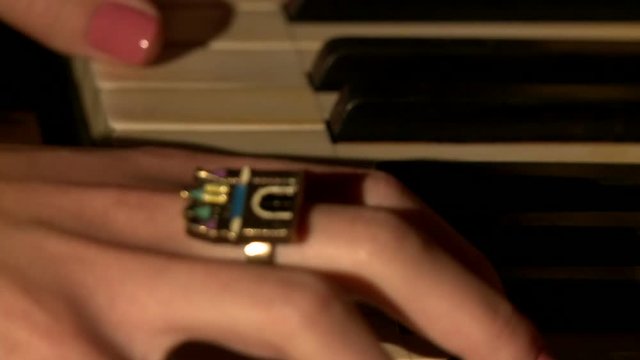 Close-up of musician's hands playing piano