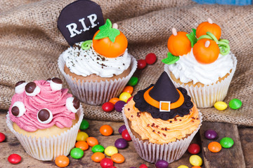 Obraz na płótnie Canvas Halloween cupcakes with colored mastic decorations