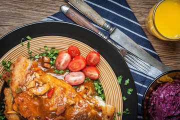Potato pancakes with meat stew served on a plate.