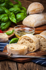 Sliced ciabatta bread on cutting board.