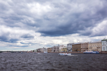 Tilt and shift view of usual dark water of Neva river under thunderstorm clouds in Saint Petersburg