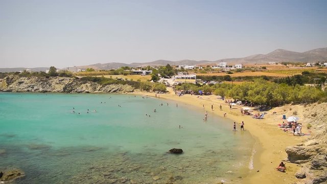 Lolalontis beach at Paros island in Greece seascape with people enjoying their summer holidays.