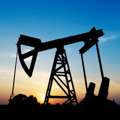 Oil rig working on a golden sunset