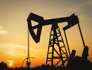 Oil rig working on a golden sunset
