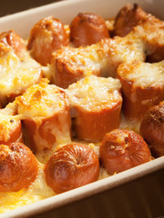 Casserole with sausage and mozzarella in a baking dish. Vertical