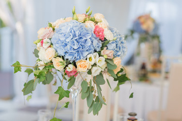 fresh floral composition on the holiday table. Beautifully organized event - served banquet tables ready for guests