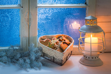 Homemade cookies on white table with blue window for Christmas