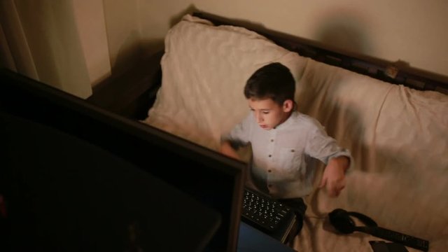 Teen boy plays games on the computer at night. Online Games