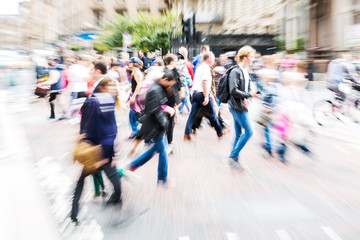 crowd of people crossing a street with zoom effect