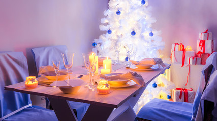 Traditionally Christmas white table setting with Christmas tree