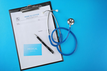 Stethoscope with medical report on blue background