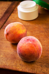Peaches and container with cream