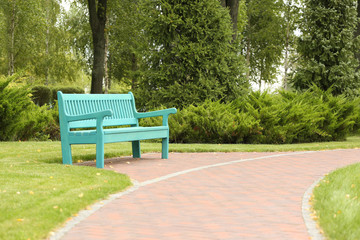 Blue wooden bench in beautiful park