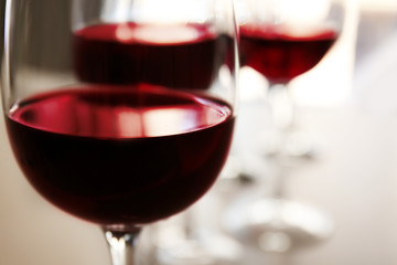 Glass of red wine on table in restaurant, closeup