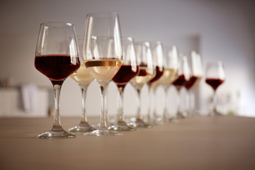 Glasses with red and white wine on table in restaurant